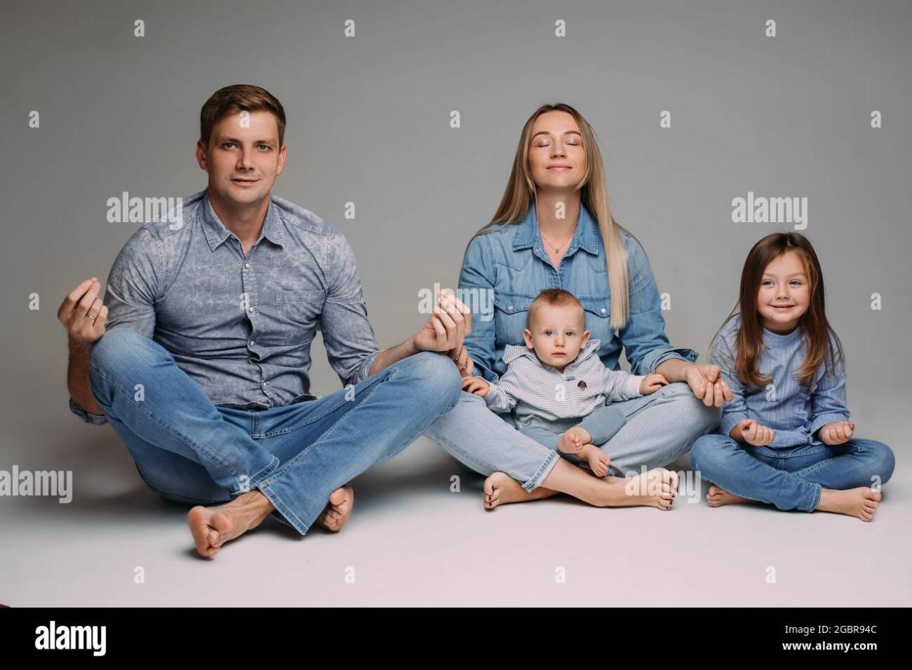 Happy family meditate together in the studio Stock Photo - Alamy